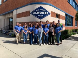 group of people standing in front of Blue Diamond Growers Almonds building